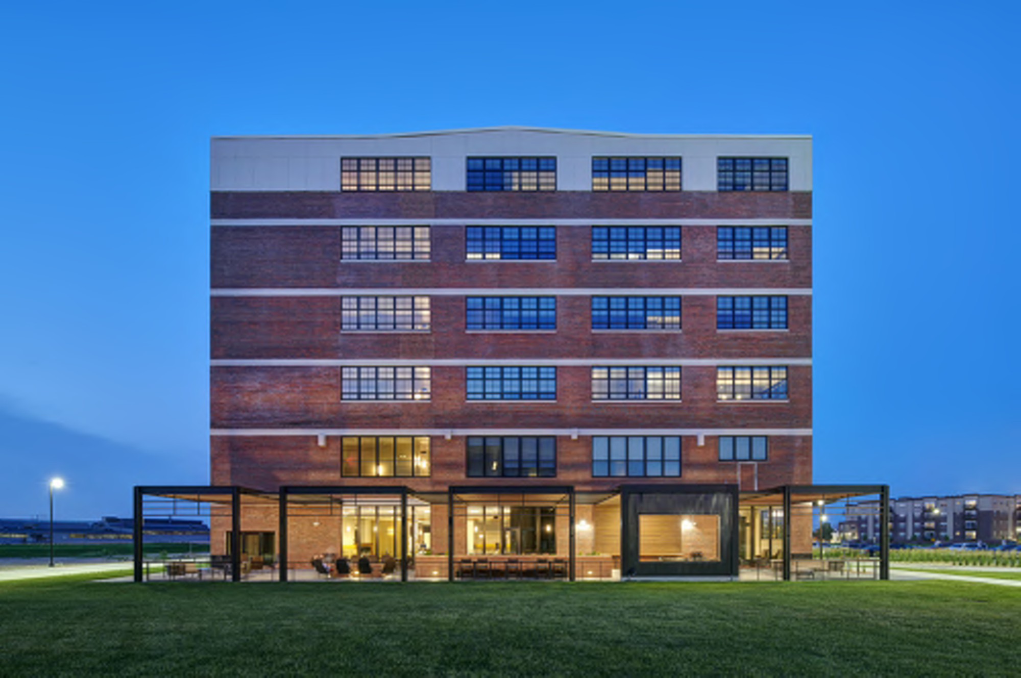 FDP Hotel exterior at dusk — a Courtyard by Marriott in a historic brick building